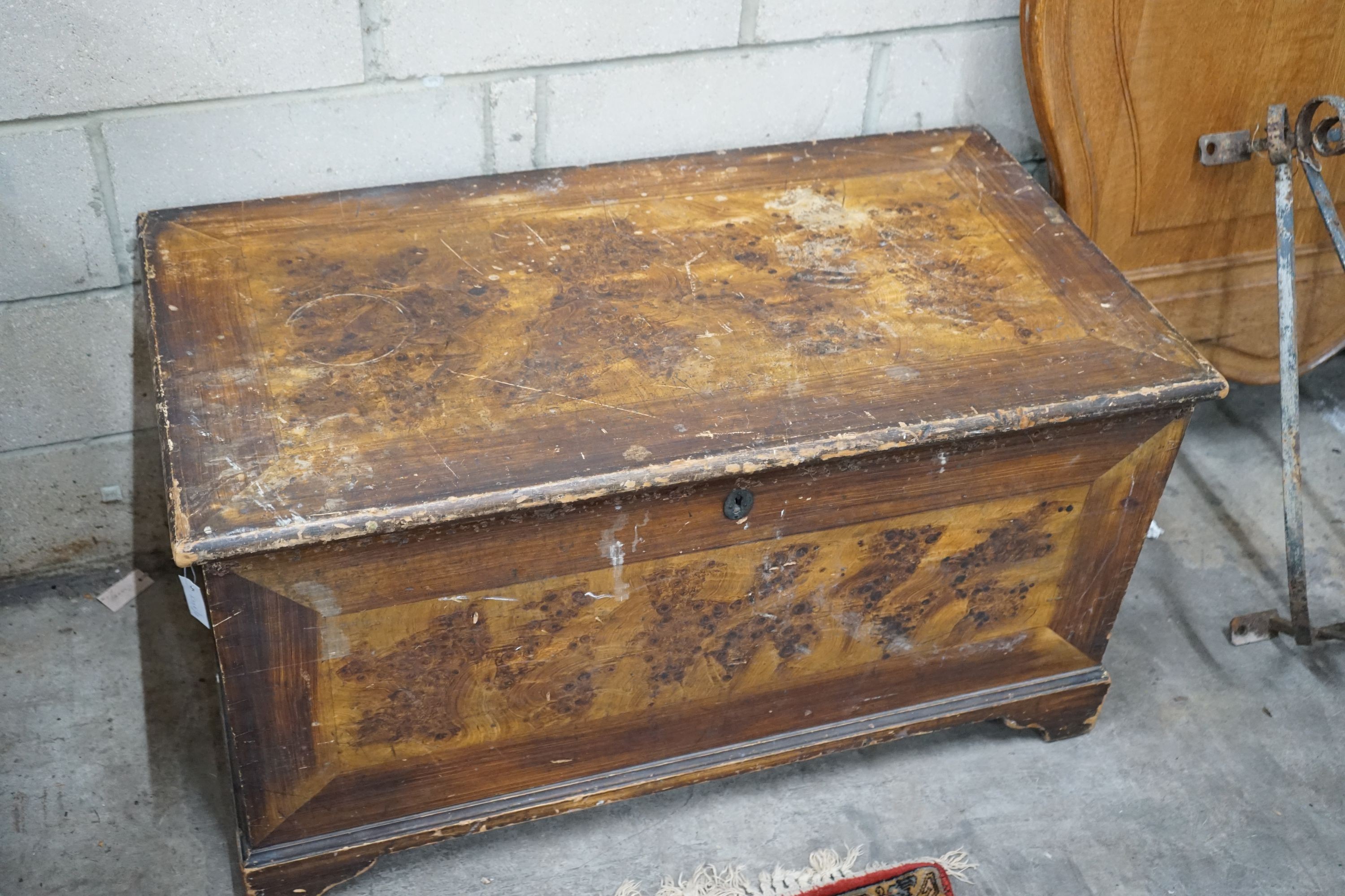 A Victorian pine trunk with simulated painted grain, width 108cm, depth 58cm, height 60cm